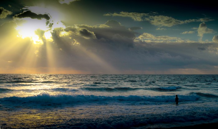 Here is a shot I took while in Florida.  I loved the perspective of how small the person is compared to  the majesty of the ocean and the suns rays washing out the entire scene.  